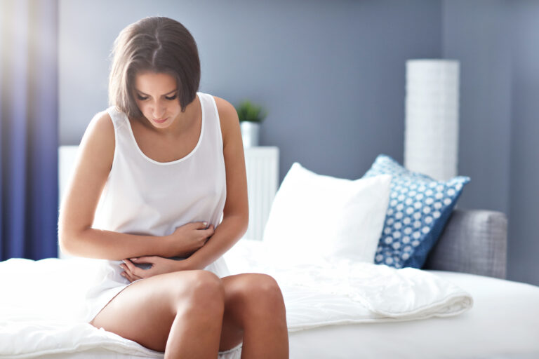 woman feeling unwell on the bed