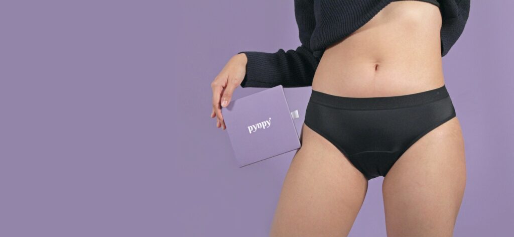 model wearing pynpy' panties holding pynpy' box