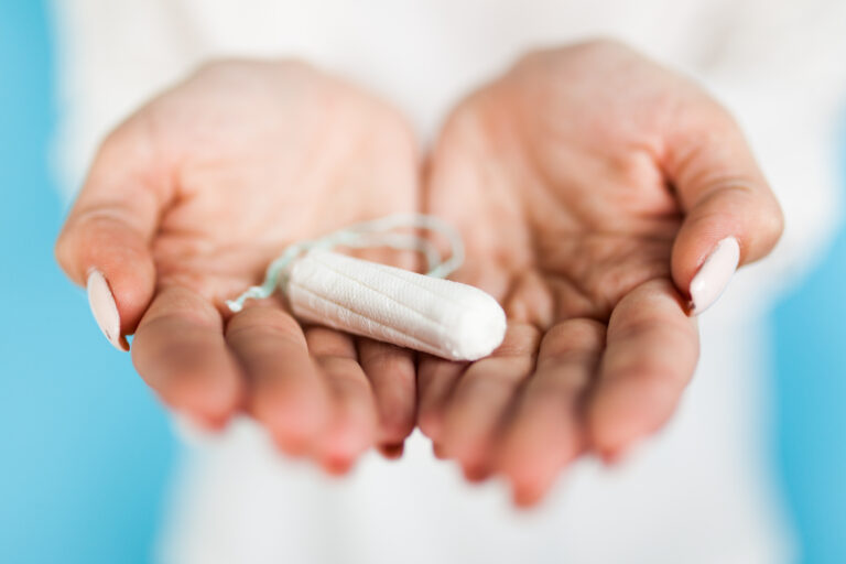 woman holding tampon with hand