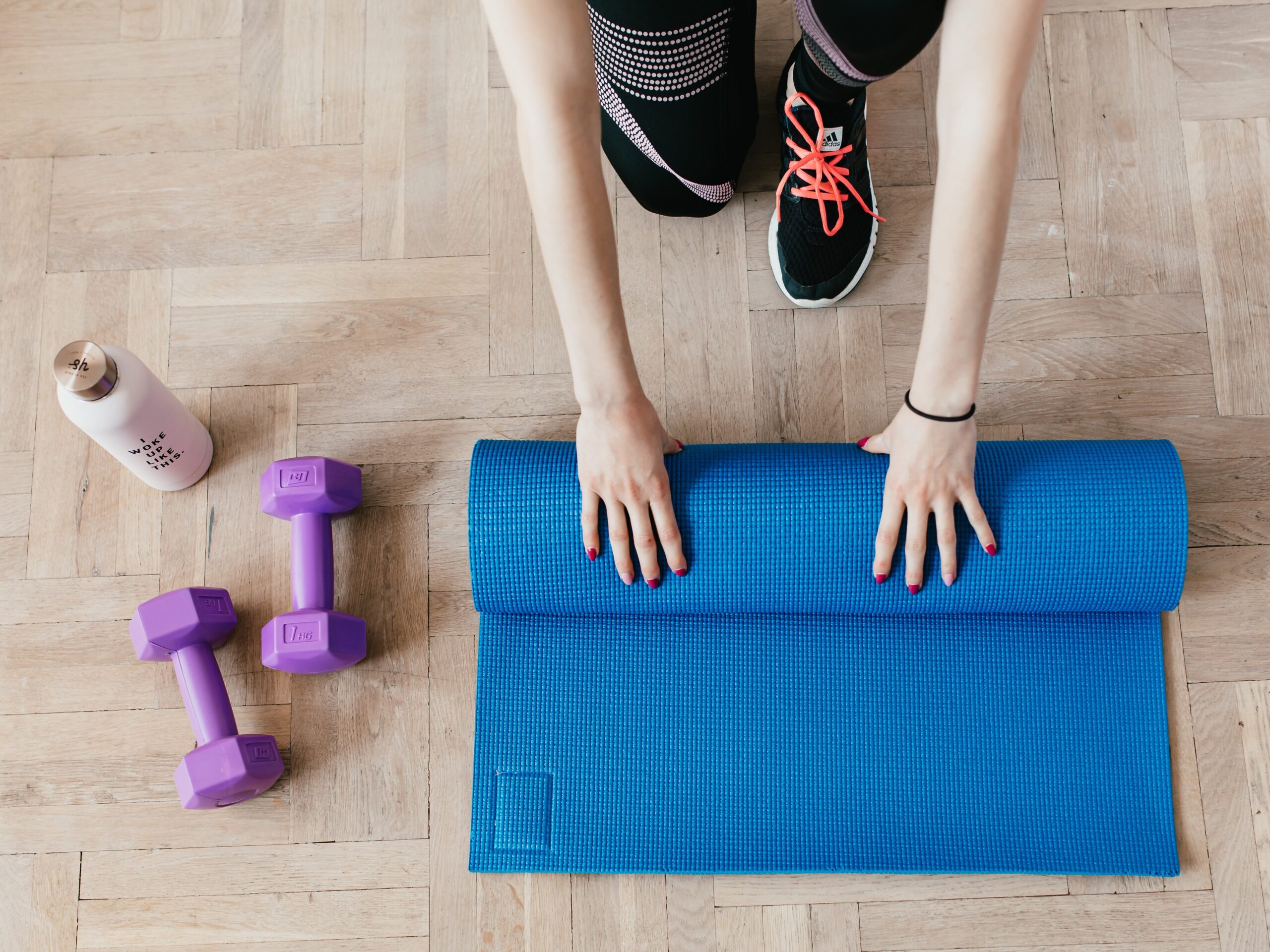 a girl is touch yoga mat